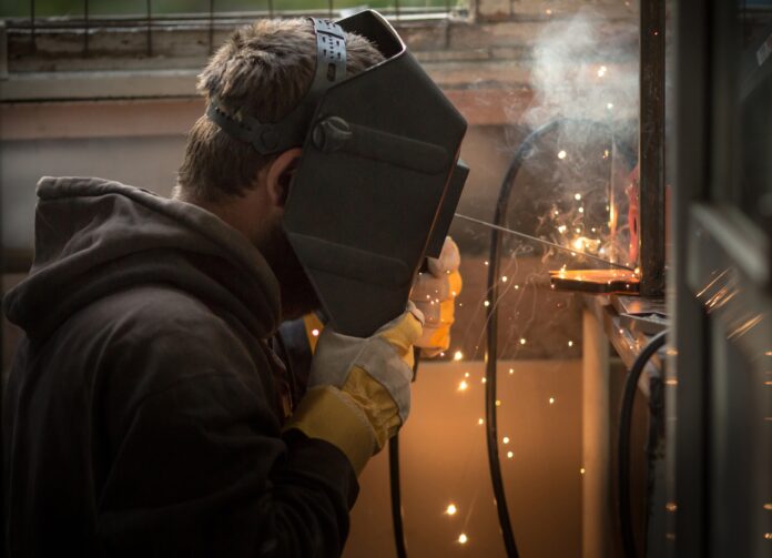 a-man-with-a-welding-machine-welds-a-metal-structu-2025-01-08-23-09-59-utc